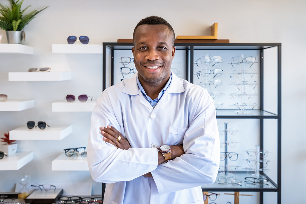 optometrist standing in front of glasses