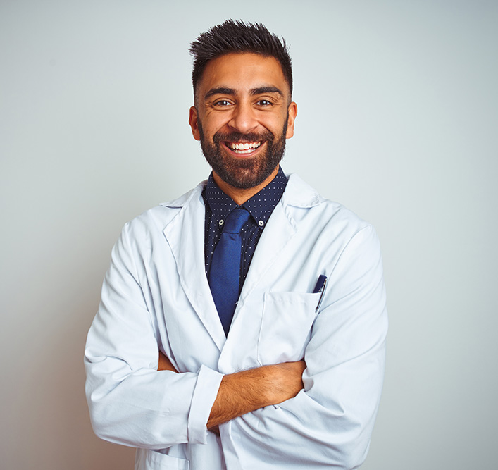 optometrist standing in front of white wall
